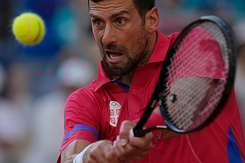 Novak Djokovic returns a shot to Lorenzo Musetti